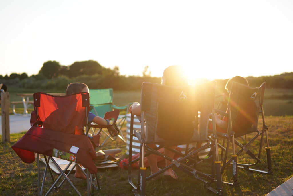 Sun setting over camping chairs